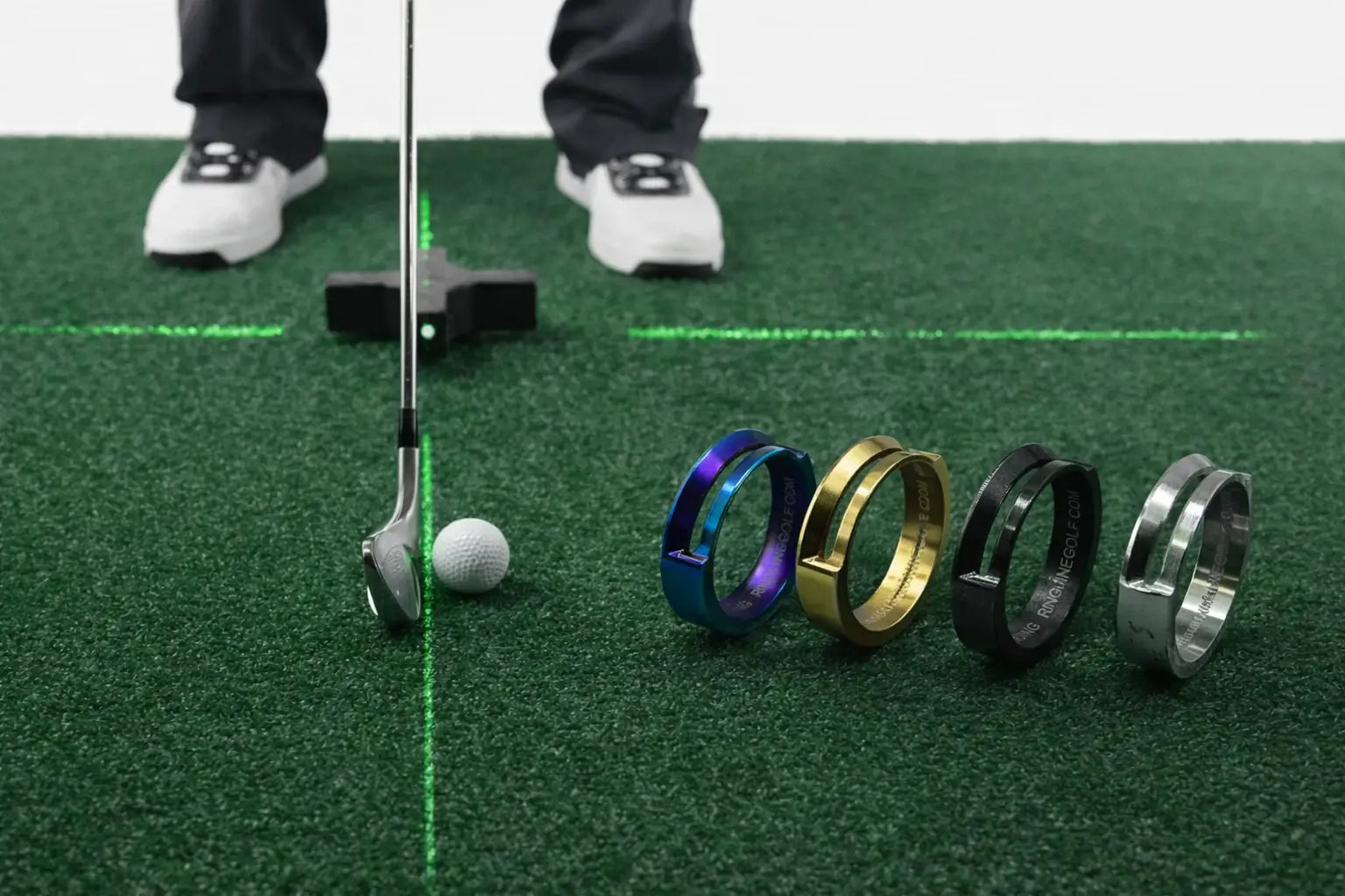 Golfer practicing putting with laser alignment guides and RingLine alignment rings on indoor turf.